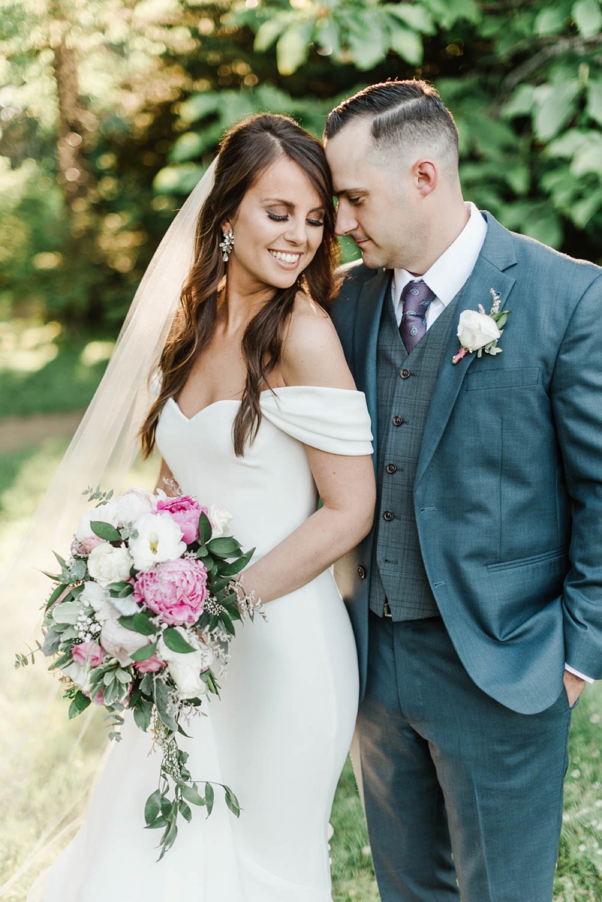 This sunny garden inspired wedding at Glen Magna Farms in Danvers, Massachusetts by Boston Wedding Photographer Annmarie Swift features beautiful floral bouquets, dusty rose bridesmaids dresses, blue suits, and a reception under sail cloth tent.